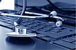 Doctor stethoscope on the laptop keyboard, image in blue tone