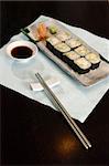 Sushi and rolls on the wooden plate