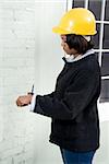 A Female Construction Inspector checking the work on a building