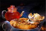 Still life with teapot, cake and pastry, very beautiful in  on a dark background. Very showy