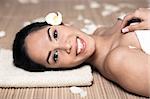 Photo of bautiful smiling woman lying down for spa treatment