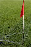 Red corner flag on an soccer field.