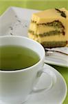 Japanese Matcha green tea with green tea cake in background