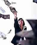 happy young business woman isolated on white playing with dollars money and representing success in finance