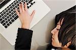 one young business woman isolated on white working on laptop computer