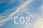 An illustration of the text CO2 made up of white puffy clouds to represent environmental issues or carbon footprint.