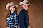 Cheerfull Cowboy and Cowgirl couple in studio