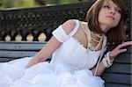 Young attractive woman in a wedding dress in different outdoor situation