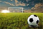 Soccer ball on penalty disk in sunset time