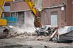 demolition squad destroy an old building to start a new development