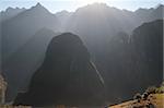 Shafts of sunlight over hills near Machu Picchu ruins