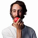 Young man eating a fresh apple