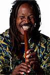 Man plays a traditional wooden flute, studio image