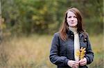 Beautiful young elegant woman in autumn forest