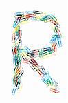 Letter R formed with colorful paperclips