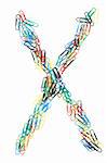 Letter X formed with colorful paperclips