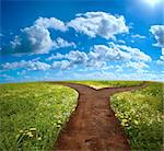 Crossroad in rural landscape on meadow hill