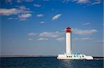 white lighthouse against the blue sky / copy space