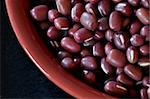 Macro view of azuki beans in a red bowl