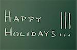 Green chalkboard with a text: Happy holidays