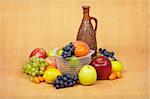 Still life of fruit and ceramic bottle of wine