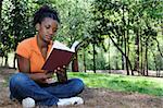 A young African American woman reading a book