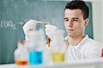 young man scientist in chemistry bright lab