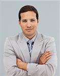 Young businessman with folded arms in front of the camera