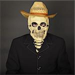 Skeleton in a straw hat on a dark background