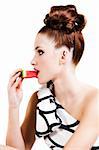 Portrait of a young woman eating watermelon. She is dressed in formal attire and viewed in profile. Vertical shot. Isolated on white.