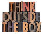 think outside the box phrase in vintage wooden letterpress type, stained by ink, isolated on white