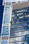 Two men cleaning windows of a skyscraper