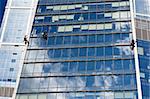 Two men cleaning windows of a skyscraper