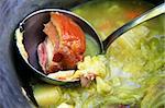 Pig-iron saucepan with cabbage soup and the big piece of meat