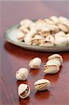 Close-up of pistachio nuts on a wooden table. Shallow dof