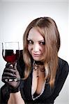 Sensual woman with glass of wine, studio shot