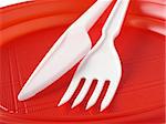 white fork and knife in the red plate