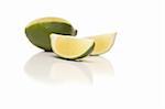 Sliced Lime on a Reflective White Surface.