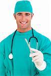 Attractive surgeon holding a scalpel against a white background