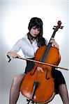 Young woman playing cello, studio shot over white background