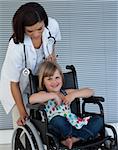 Female doctor pushing a wheelchair in the hospital