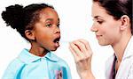 Female doctor taking little girl's temperature against a white background