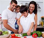 Affectionate young family cooking together in the kitchen at home