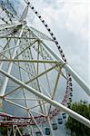 Big ferris wheel, view from ground. Sky with clouds on the background. Harbin city in China.