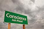 Conscience Just Ahead Green Road Sign with Dramatic Storm Clouds and Sky.