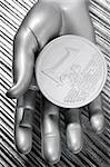 euro silver coin of futuristic metallic silver hand money metaphor