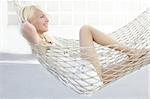 beautiful blonde young girl relaxed on hammock profile