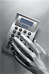 business futuristic silver hand metaphor on calculator keyboard