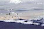 aerogenerator electric windmills snow mountain blurred foreground