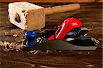 planer carpenter hand tool wood shaving over wooden board